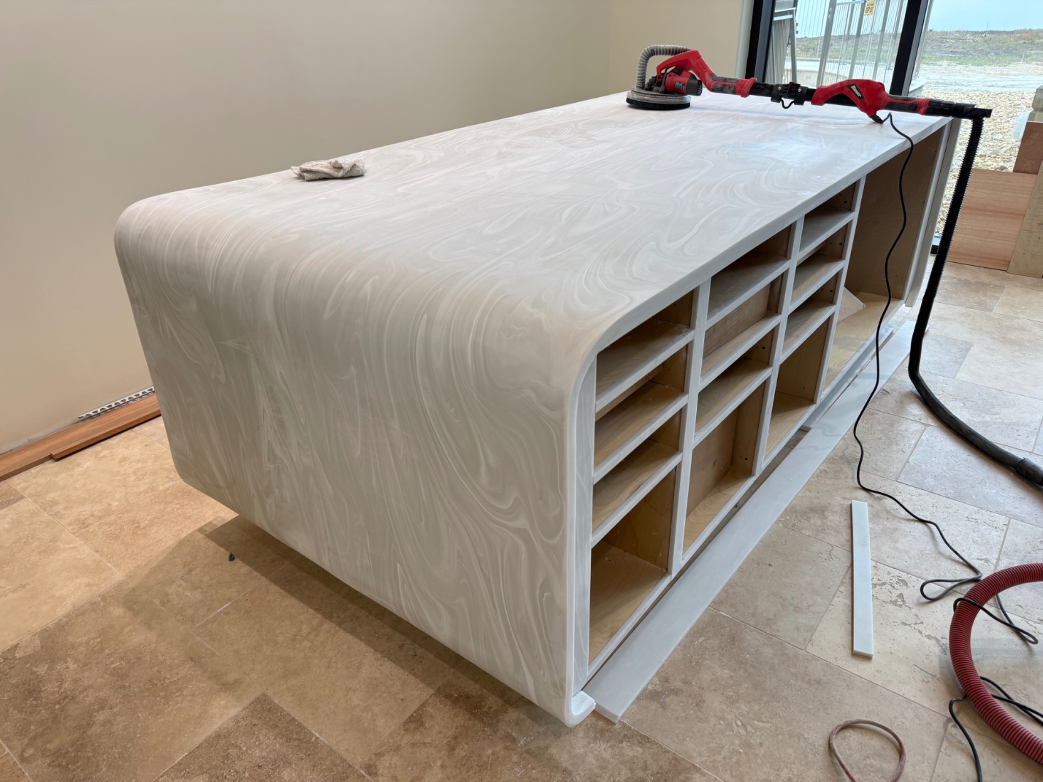 Sculpted pale solid-surface island during finishing