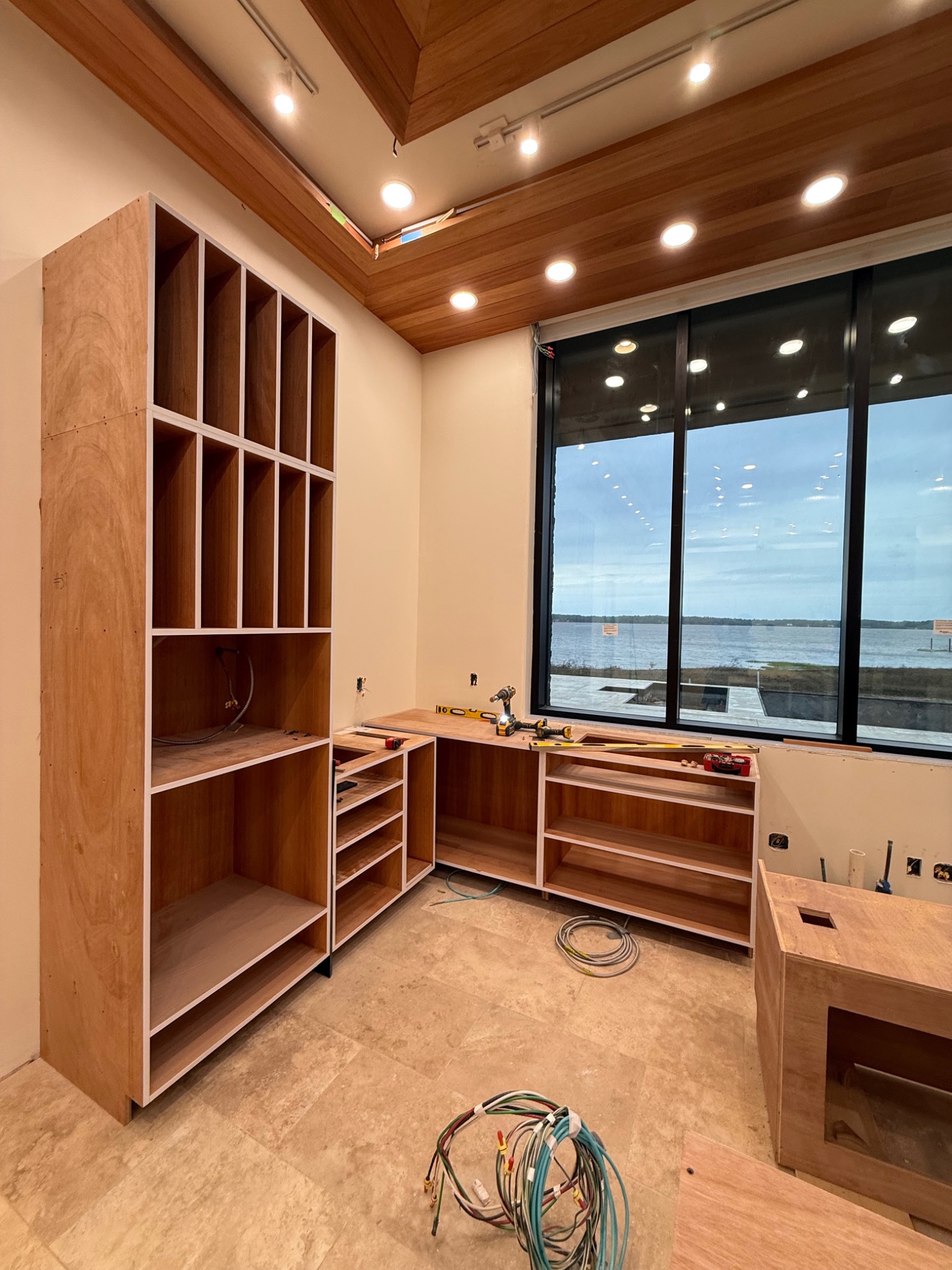 Waterfront custom cabinetry under wood ceiling